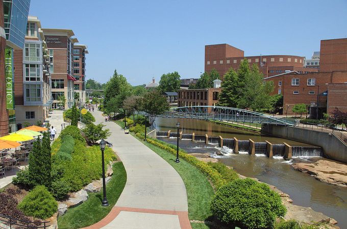 A river runs through a city with buildings in the background
